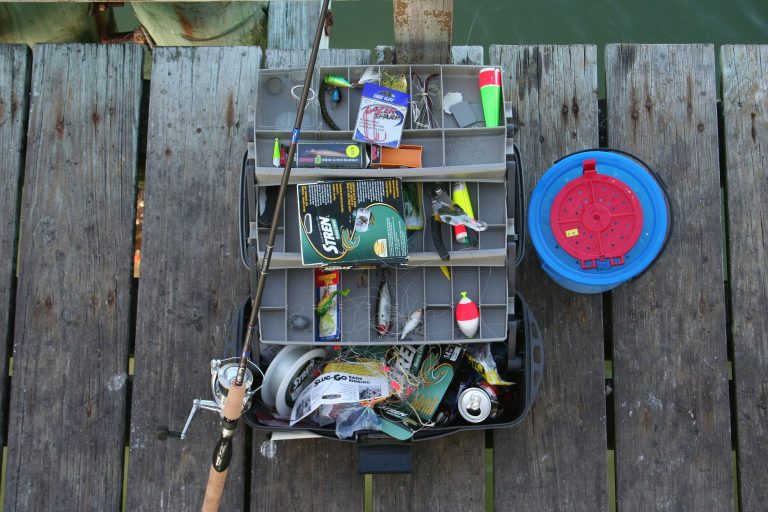 An example of commonly used trout fishing equipment; Tackle box with rod and lures.